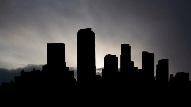 Downtown of Denver, Time Lapse at Sunrise with Fast Clouds and Dark Silhouette of Skyscrapers, Colorado