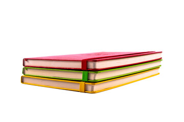 Closed paper notebooks in red, green and yellow color. Planner isolated on transparent png background. Design template of copybook with elastic band for mockup. 