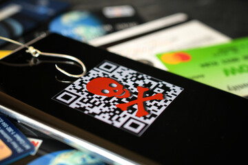 QR code scam concept - scanning a fraudulent QR code can lead to phishing websites or malware apps.
