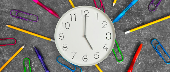 5 o'clock. Banner. Study or business time. Clock  with white clock face on dark background with...