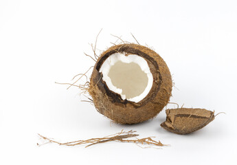 Broken coconut on a white background. Tropical fruit concept. Coconut flakes.