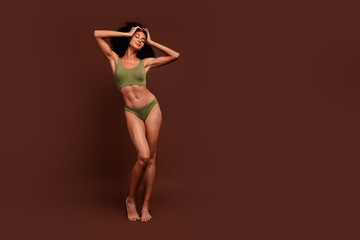 Fototapeta na wymiar No filter full length photo of gorgeous girl sporty strong ideal body wear khaki lingerie empty space isolated on brown color background
