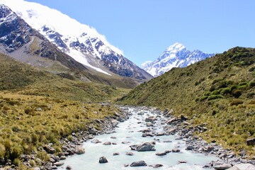 New Zealand river and mountains in the back with snow green gras © LetsSeeGoodWaves