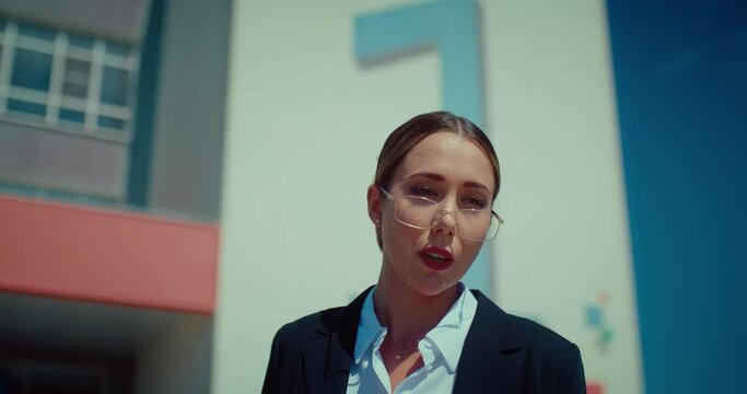 Beautiful young woman teacher with glasses on face outdoors, portrait of talking lady, 4K, Prores