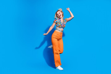 Full length photo of positive pretty person enjoy dancing have good mood isolated on blue color background