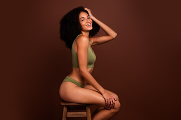 Profile side no filter photo of cheerful stunning girl wear casual khaki lingerie sporty aesthetic body isolated on brown color background