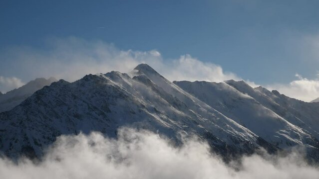 mountains arising from cloud, sunny blue sky with mist