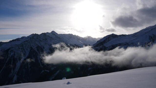 mountain peaks, sunny day, rising from clouds