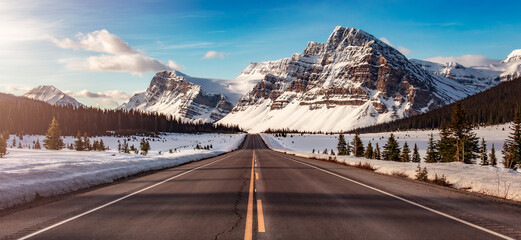 Road with Canadian Rocky Mountain Peaks Covered in Snow. Banff - obrazy, fototapety, plakaty