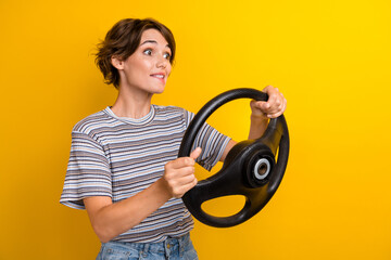 Portrait of speechless girl wear grey t-shirt hold steering wheel astonished staring at empty space...