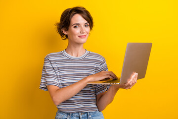 Portrait of intelligent nice girl with short hairdo wear grey t-shirt holding laptop typing email...