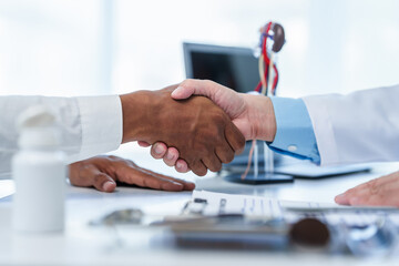 close-up handshake between two individuals, doctor and other casual shirt. doctor-patient relationship, agreement on treatment plan,  conclusion of medical consultation. - obrazy, fototapety, plakaty