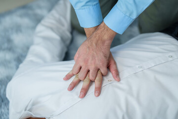 Close up man lying down while another individual, likely a medical professional, is performing a...