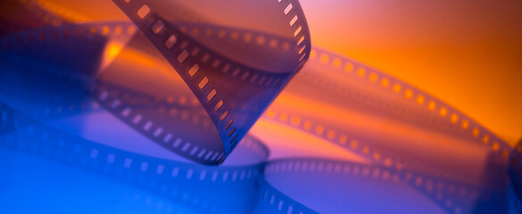 multicolored cinema background with film strip - obrazy, fototapety, plakaty