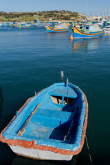 Fototapeta na wymiar Small fishing boat. Malta. Overall plan.