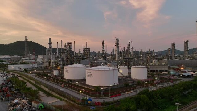 Oil and gas industrial refinery at twilight, Oil refinery and Petrochemical plant pipeline steel, Refinery factory oil storage tank and pipeline steel at night.