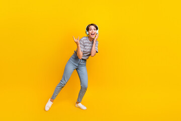 Fototapeta na wymiar Full size photo of carefree positive girl demonstrate heavy metal symbol empty space isolated on yellow color background