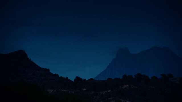 Timelapse of night is falling over Peak Puig Campana. Alicante province, municipality of Finestrat. View from Xarco coast.
