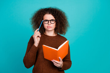 Photo of pensive lady in brown jumper touch eyeglasses with her pencil thinking how to write book...