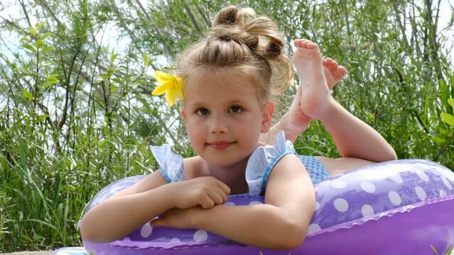 Pretty girl resting comfortably in swimming float ring on the beach. Relaxing, happy travel and vacations