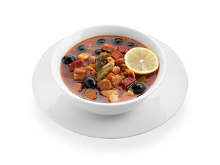 Meat solyanka soup with sausages, olives and vegetables in bowl isolated on white
