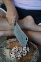 The cook uses a knife to cut the roast pork into small pieces that are easy to eat.