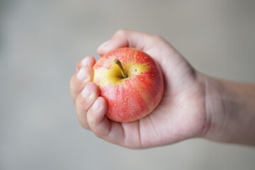 Human hand holds fresh apple