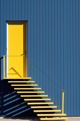 yellow door and staircase in a house with a blue wall
