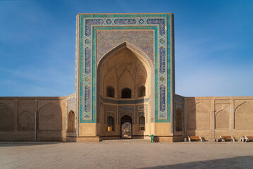The main entrance to the Kalyan Mosque is the main Friday mosque of Bukhara on a sunny day,...