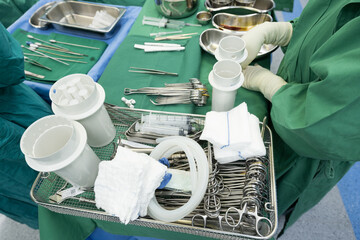 Surgeon in sterile gloves getting ready medical instruments.Surgical clamps and medical equipment...