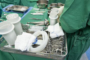 Surgeon in sterile gloves getting ready medical instruments.Surgical clamps and medical equipment...