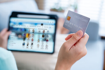 Close-up of shopping page on tablet and credit card