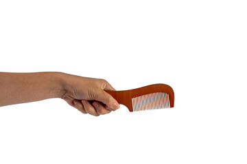 Hand and wood hair comb isolated on transparent background
