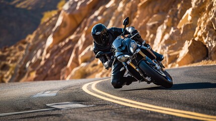 Motorcyclist Riding on a Curvy Mountain Road at Sunset, Wearing Black Safety Gear and Riding a Modern Sport Motorcycle