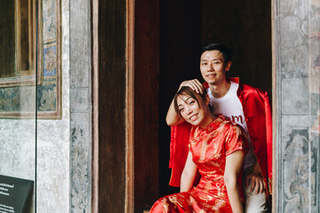 Happy young Asian couple in Chinese traditional dresses