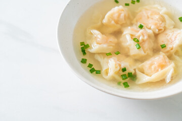 shrimp dumpling soup in white bowl