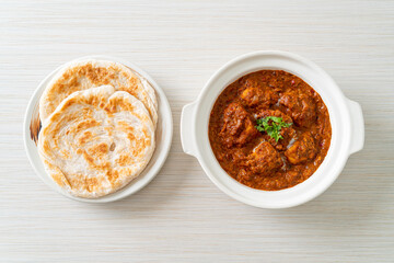 chicken tikka masala spicy curry meat food with roti or naan bread