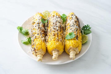 barbecue and grilled corn with cheese and lime