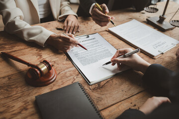 Business people negotiating a contract, discussing contract while working together in sunny modern office, unknown businessman and woman with colleagues or lawyers at meeting. - obrazy, fototapety, plakaty