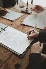 Business people negotiating a contract, discussing contract while working together in sunny modern office, unknown businessman and woman with colleagues or lawyers at meeting. - obrazy, fototapety, plakaty