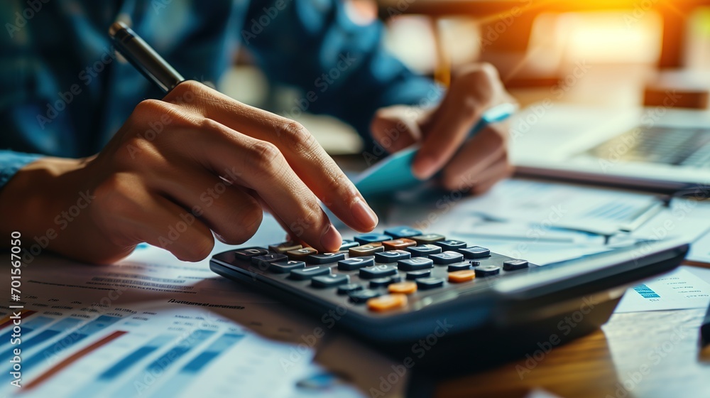 Aufkleber accountant working on desk in office using calculator to calculate budget