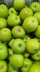 Close up pile of tasty fresh apples sold at the market as a background.