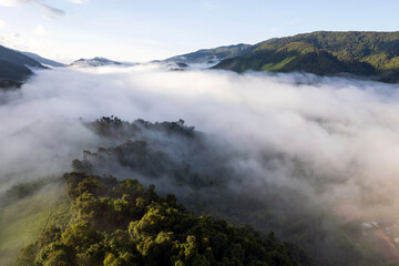 Top view Landscape of Morning Mist with Mountain Layer at north of Thailand. mountain ridge and clouds in rural jungle bush forest