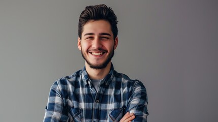 Happy young man. Portrait of handsome young man in casual shirt keeping arms crossed - obrazy, fototapety, plakaty