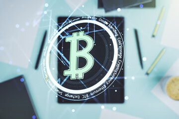 Double exposure of creative Bitcoin symbol and digital tablet on background, top view. Cryptocurrency concept