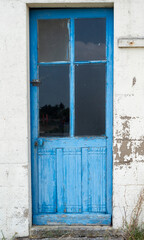 old house white wall with blue door