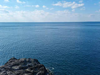 The blue sea and sky seen from the cliff.