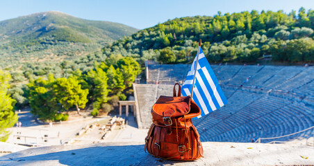 Travel destination in Greece- bag and greek flag, Famous touristic site of Epidaurus