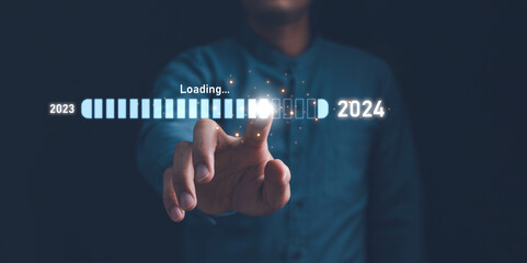 Businessman touch on loading progress from 2023 to 2024,Planning and challenge strategy in new year 2024 Concept. New business startup in 2024. New year 2024 is loading, calendar date, end of the year