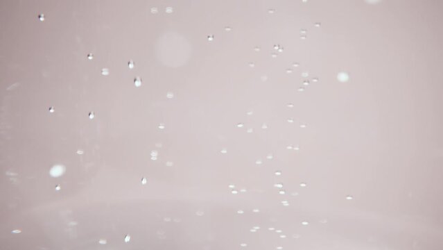 A macro video showing bubbles in seltzer water